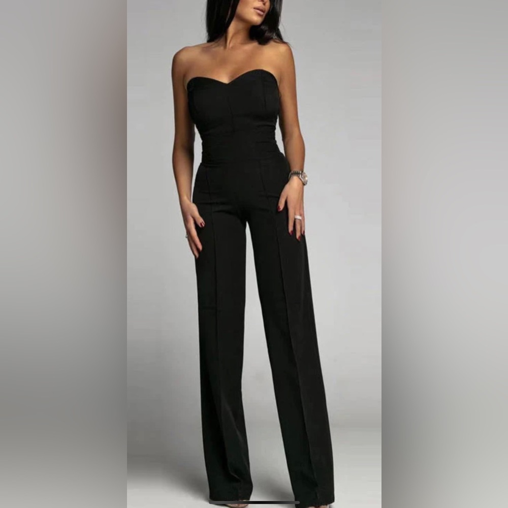 Black jumpsuit. Never worn. Side zipper. Stretchy material.